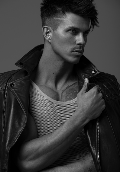 Kenny Braasch modeling a mesh tank top and leather jacket in black and white.