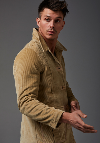 Kenny Braasch modeling a long brown corduroy coat.